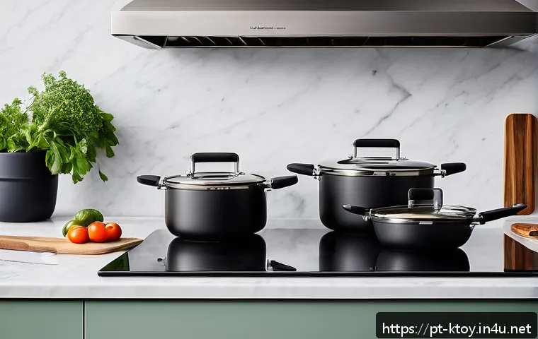 주방완구 가격대 비교 - A modern kitchen countertop featuring a set of stainless steel cookware with triple-layered bottoms,...
